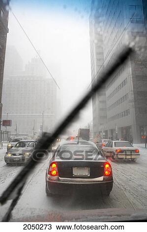 Stock Image - View Of Traffic In A Snow Storm Through A Car Windshield, Front Street, Toronto, Ontario. Fotosearch