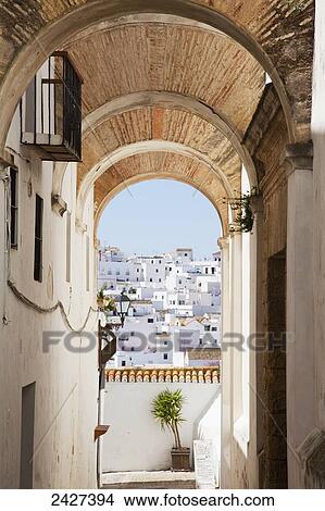 View of whitewashed buildings from an arched corridor; Veyer de la Frontera, Andalucia, Spain View Large Photo Image Picture - View of whitewashed buildings from an arched corridor; Veyer de la Frontera, Andalucia, Spain. Fotosearch