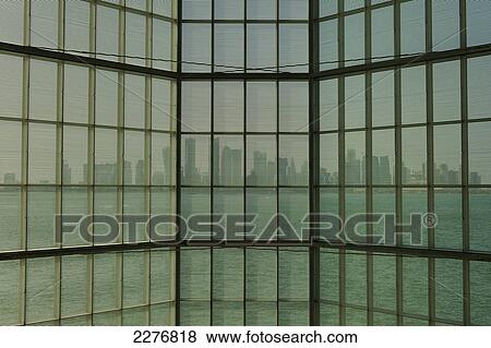 View out of large window in the Museum of Islamic Art to the modern city skyline of Doha; Doha, Qatar View Large Photo Image Stock Photo - View out of large window in the Museum of Islamic Art to the modern city skyline of Doha; Doha, Qatar. Fotosearch