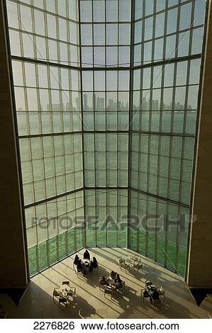 Stock Photograph - View out of large window in the Museum of Islamic Art to the modern city skyline of Doha; Doha, Qatar. Fotosearch