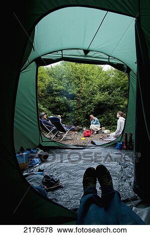 View Out Of Tent To People Beside Campfire At Blackberry Wood Campsiteplumpton, East Sussex, Uk. 
 View Large Photo Image Stock Photo - View Out Of Tent To People Beside Campfire At Blackberry Wood Campsiteplumpton, East Sussex, Uk. 
. Fotosearch