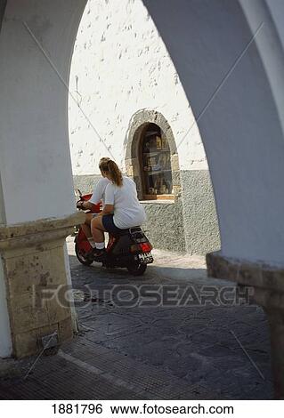 View Through Arch To Couple On A Moped. View Large Photo Image Stock Photograph - View Through Arch To Couple On A Moped.. Fotosearch