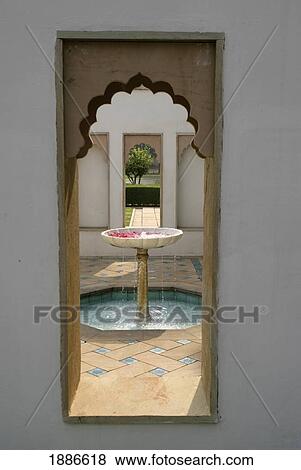 Stock Photo - View Through Arched Window To Fountain. Fotosearch