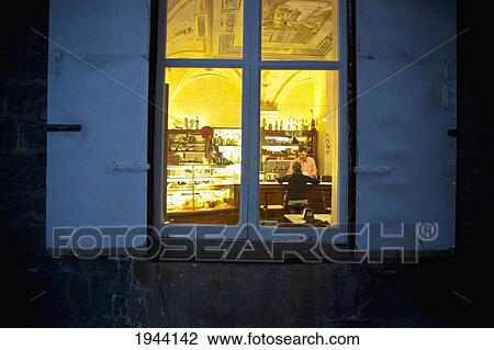 View Through The Window Of A Man Sitting At A Bar At Night; Genoa Liguria Italy View Large Photo Image Stock Image - View Through The Window Of A Man Sitting At A Bar At Night; Genoa Liguria Italy. Fotosearch