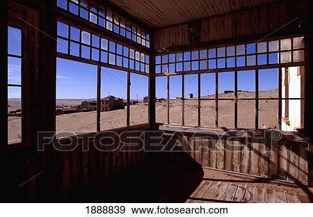 Stock Photo - View Through Windows Of Disused Building In Desert Ghost Town. Fotosearch