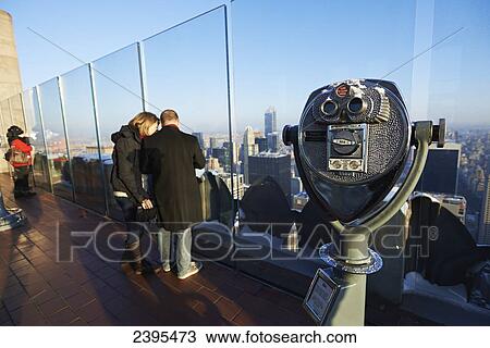 Stock Image - Viewing glasses on Rockefeller center viewing platform looking towards central park; New York City, New York, United States of America. Fotosearch