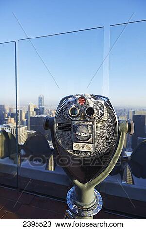 Stock Image - Viewing glasses on Rockefeller center viewing platform looking towards central park; New York City, New York, United States of America. Fotosearch