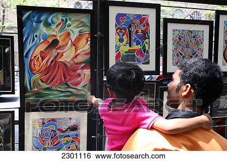 Viewing the artwork on display at Kala Ghoda Street Pavement Exhibition; Mumbai, Maharashtra State, India View Large Photo Image Stock Photograph - Viewing the artwork on display at Kala Ghoda Street Pavement Exhibition; Mumbai, Maharashtra State, India. Fotosearch
