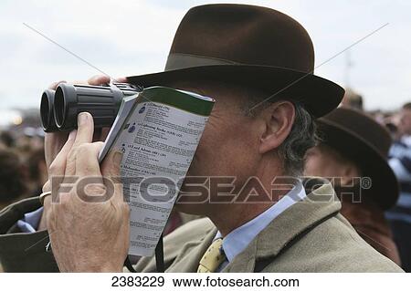 Stock Photo - Viewing the horse racing at club enclosure, one of the best viewing areas, at Cheltenham horse racing festival on gold cup day, Prestbury; Cheltenham, Gloucestershire, England. Fotosearch