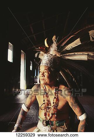 Village chief sitting in a Long House in traditional dress; Sarawak View Large Photo Image Stock Photo - Village chief sitting in a Long House in traditional dress; Sarawak. Fotosearch