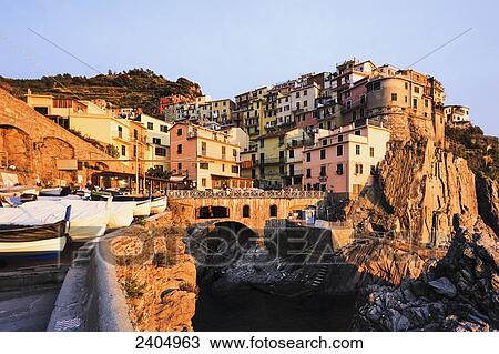 Stock Image - Village of Manarola at sunset, Cinque Terre; Manarola, Liguria, Italy. Fotosearch