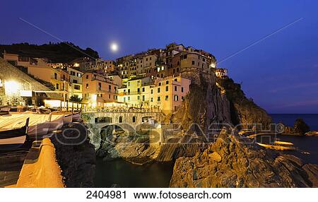 Stock Image - Village of Manarola at sunset, Cinque Terre; Manarola, Liguria, Italy. Fotosearch