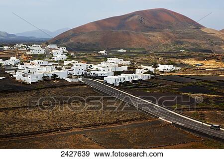 Vineyards and white buildings in a city; Lanzarote, Spain View Large Photo Image Stock Photo - Vineyards and white buildings in a city; Lanzarote, Spain. Fotosearch