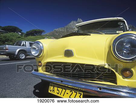 Stock Photograph - Vintage Car In Clifton Beach Beneath Table Mountain; Cape Town, South Africa. Fotosearch