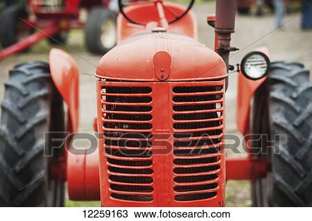 Stock Image - Vintage red tractor; Knoxville, Pennsylvania, United States of America. Fotosearch
