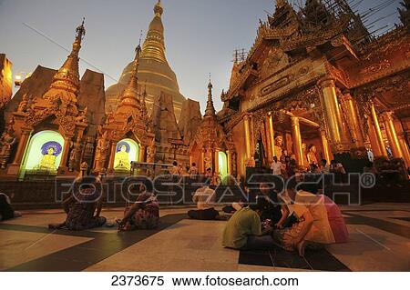 Visitors at Shwedagon Pagoda at sunset; Yangon, Burma View Large Photo Image Stock Photography - Visitors at Shwedagon Pagoda at sunset; Yangon, Burma. Fotosearch