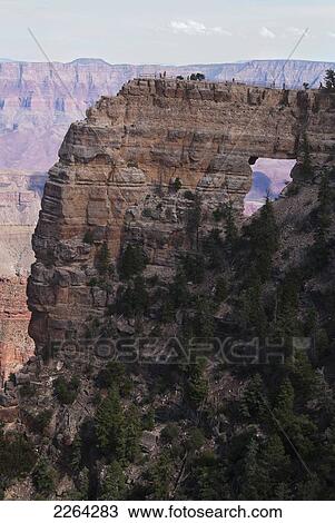 Stock Image - Visitors explore top of angel's window on north rim of grand canyon; kanab arizona usa. Fotosearch