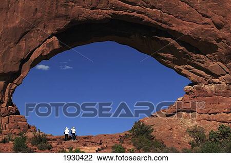 Stock Image - Visitors Looking At One Of The Large Openings In Window Arches.. Fotosearch
