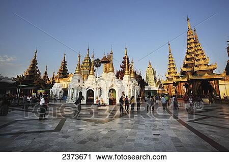 Visitors walk around Shwedagon Pagoda at sunset; Yangon, Burma View Large Photo Image Stock Image - Visitors walk around Shwedagon Pagoda at sunset; Yangon, Burma. Fotosearch