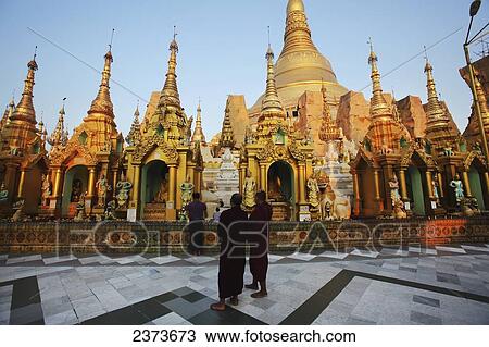 Visitors walk around Shwedagon Pagoda at sunset; Yangon, Burma View Large Photo Image Stock Image - Visitors walk around Shwedagon Pagoda at sunset; Yangon, Burma. Fotosearch
