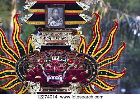 Picture - Wadah, a temple-shaped structure made of paper and light wood, containing the ashes of the deceased in a funeral procession to deposit the ashes in the Unda river following the Ngaben or Cremation Ceremony, Klungkung, Bali, Indonesia. Fotosearch