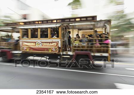 Stock Photo - Waikiki trolley speeding down the street; Oahu, Hawaii, United States of America. Fotosearch