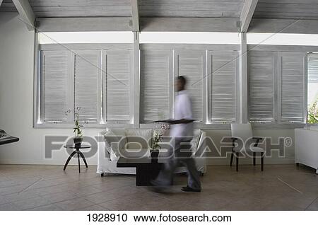 Stock Image - Waiter Walking Through Bar Of Carlisle Bay Hotel; Antigua. Fotosearch