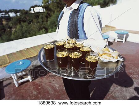 Stock Photo - Waiter With A Tray Of Drinks And Snacks.. Fotosearch