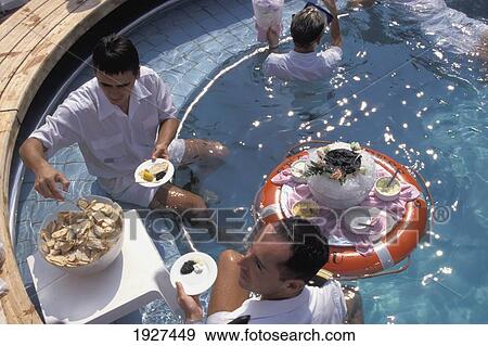 Waiters Serve Caviar And Drinks In The Pool On Board Cunard's Sea Goddess Ii View Large Photo Image Stock Photo - Waiters Serve Caviar And Drinks In The Pool On Board Cunard's Sea Goddess Ii. Fotosearch