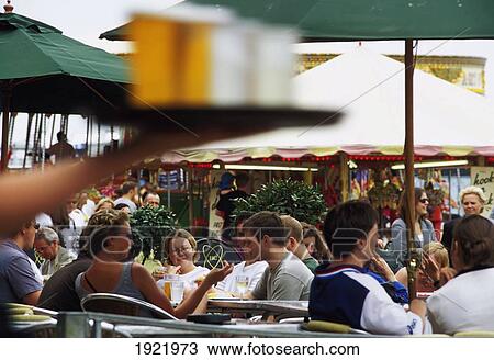 Stock Image - Waitress Carrying A Tray Of Beer. Fotosearch