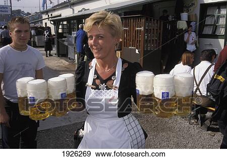 Stock Photo - Waitress Serving Beer At Oktoberfest; Munich, Bavaria, Germany. Fotosearch