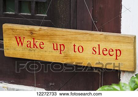 Stock Image - Wake up to sleep sign, Hongcun, Anhui, China. Fotosearch