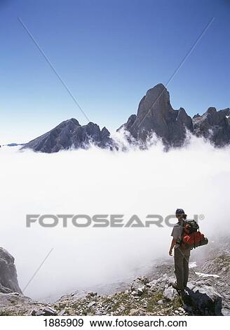 Walker Above The Clouds Looking Over Mt. Bulnes De Naranja View Large Photo Image Stock Photo - Walker Above The Clouds Looking Over Mt. Bulnes De Naranja. Fotosearch