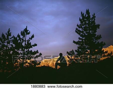 Stock Image - Walker Admiring The Dusk Light At Haut Asco Near Monte Cinto. Fotosearch