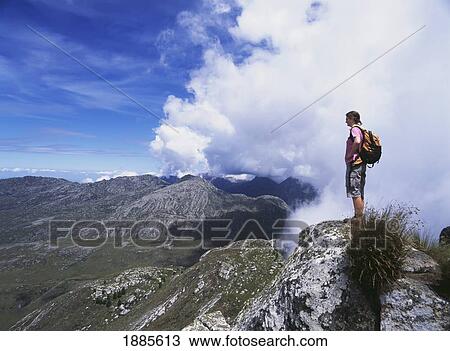 Stock Image - Walker Admiring View From Namasile Peak. Fotosearch