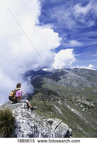 Stock Photography - Walker Admiring View From Namasile Peak. Fotosearch