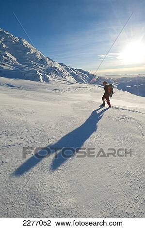 Stock Image - Walker going through heavy snow up Beinn Respiol, Ardnamurchan peninsula; Highlands, Scotland. Fotosearch