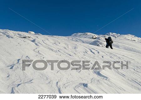 Stock Photo - Walker going through heavy snow up Beinn Respiol, Ardnamurchan peninsula, Highlands, Scotland. Fotosearch