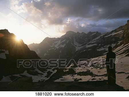 Stock Image - Walker Having A Cup Of Tea Beside The Refuge Breche De Roland. Fotosearch