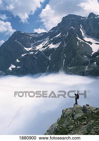 Walker Looking Over Sea Of Clouds Towards The Cirque De Gavarnie View Large Photo Image Stock Image - Walker Looking Over Sea Of Clouds Towards The Cirque De Gavarnie. Fotosearch