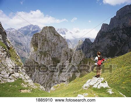 Stock Image - Walker Looking Over The Scenery Of The Picos De Europa Mountains. Fotosearch