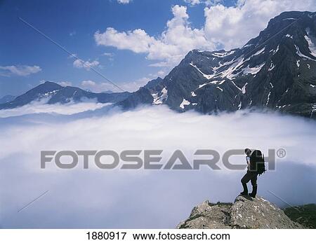 Walker On The Edge Of A Cliff Amongst The Clouds At Cirque De Gavarnie View Large Photo Image Stock Photo - Walker On The Edge Of A Cliff Amongst The Clouds At Cirque De Gavarnie. Fotosearch