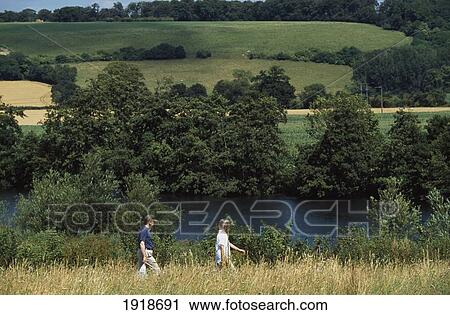 Stock Image - Walkers Along The Thames In Henley. Fotosearch