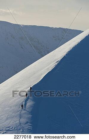 Walkers climbing snowy ridge of Sgorr Dhearg in winter near Glen Coe; Highlands, Scotland View Large Photo Image Stock Photo - Walkers climbing snowy ridge of Sgorr Dhearg in winter near Glen Coe; Highlands, Scotland. Fotosearch