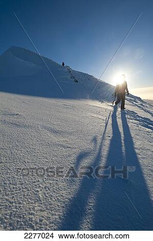 Walkers descending the snowy slopes of Sgorr Dhearg in winter near Glen Coe; Highlands, Scotland View Large Photo Image Picture - Walkers descending the snowy slopes of Sgorr Dhearg in winter near Glen Coe; Highlands, Scotland. Fotosearch