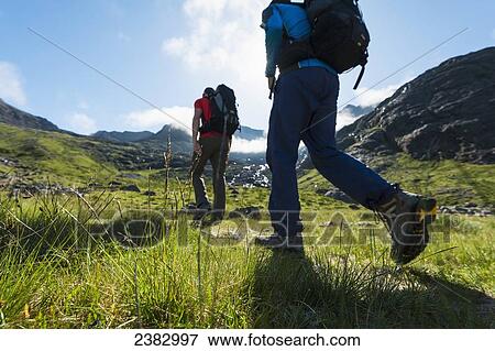 Stock Photo - Walkers going up a path to the Black Cuillin; Isle of Skye, Scotland. Fotosearch