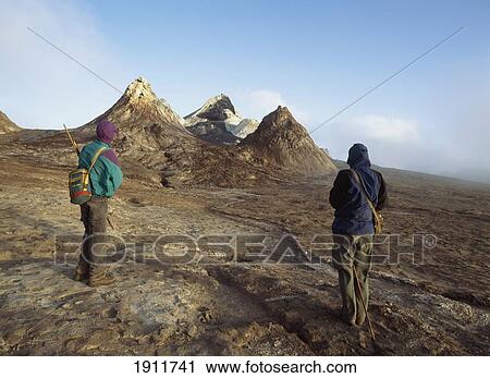 Walkers Looking At Lava Cones Shortly After Dawn On The Summit Of Ol Donyo Lengai, East Africa's Only Active Volcano, Tanzania. View Large Photo Image Stock Image - Walkers Looking At Lava Cones Shortly After Dawn On The Summit Of Ol Donyo Lengai, East Africa's Only Active Volcano, Tanzania.. Fotosearch