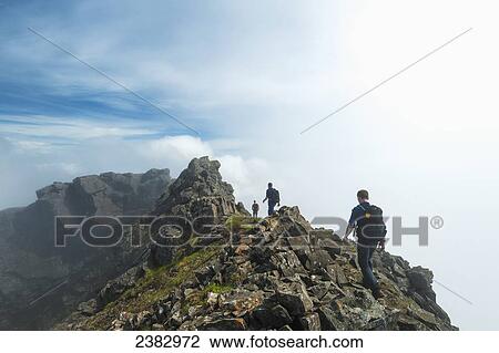 Stock Image - Walkers on ridge near the top of Sgurr Alasdair in the Black Cuillin; Isle of Skye, Scotland. Fotosearch
