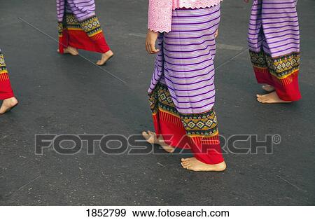 Stock Photo - Walking Barefoot In Costume, Flower Festival; Chiang Mai, Thailand. Fotosearch
