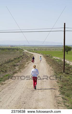Stock Photo - Walking down a rural road; Andalusia, Spain. Fotosearch